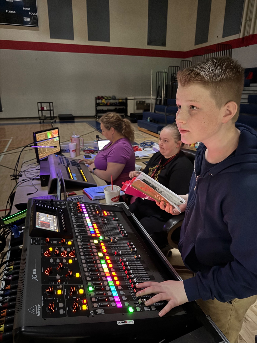 Middle school student operating Behringer X32 at school production in Meridian Idaho, youth audio training