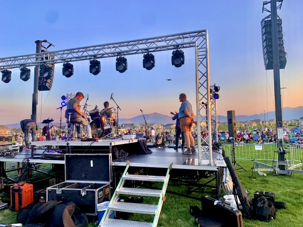 Outdoor festival stage at sunset with truss lighting and line array sound by SwissMixx Audio, serving Idaho and Utah event planners
