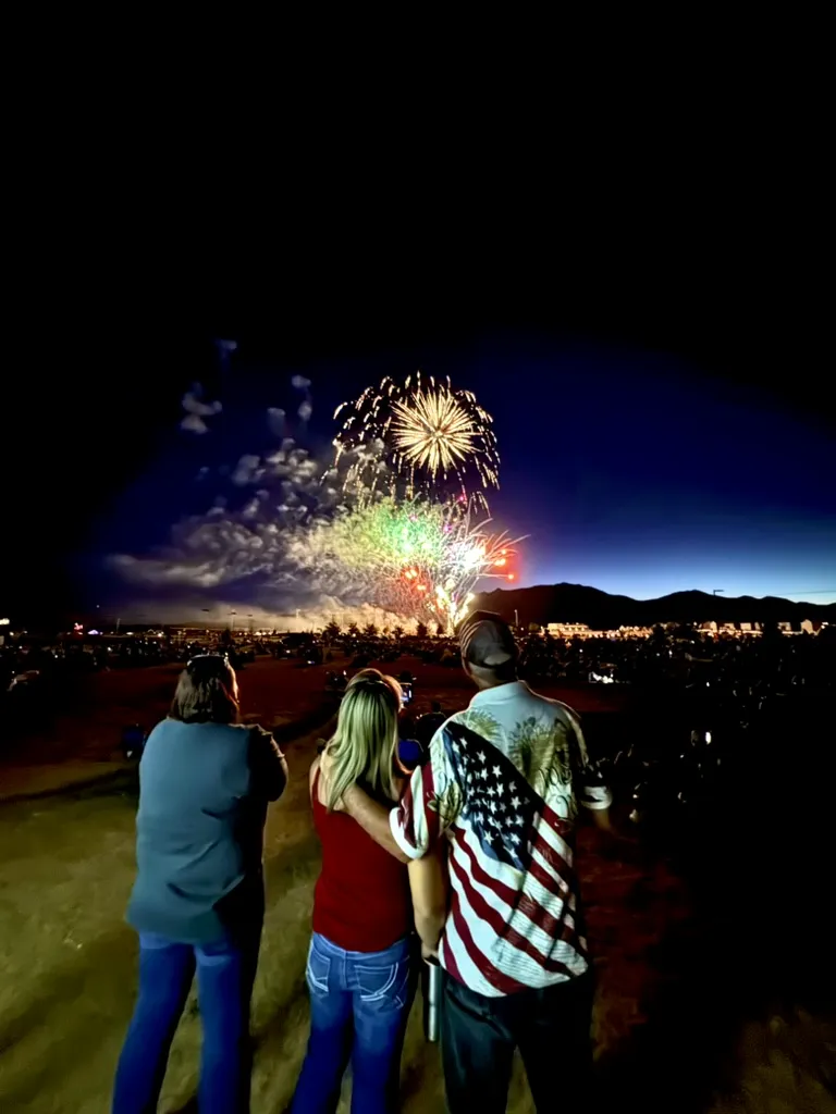 Family watching a fireworks finale with an American flag, synchronized soundtrack by SwissMixx Audio