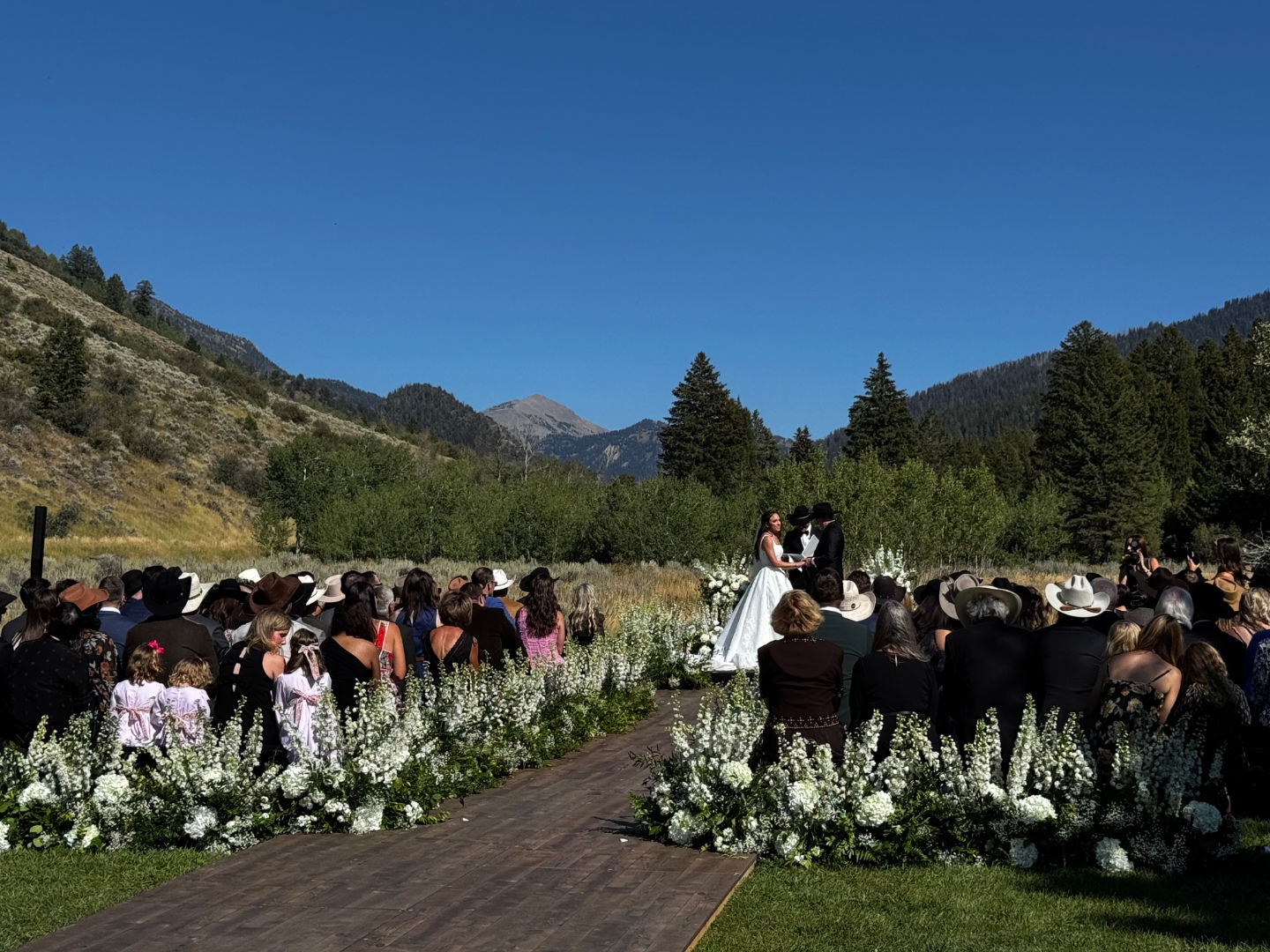 Outdoor wedding ceremony with Teton mountain backdrop, bride and groom at altar, SwissMixx Audio destination wedding DJ Jackson Hole Wyoming