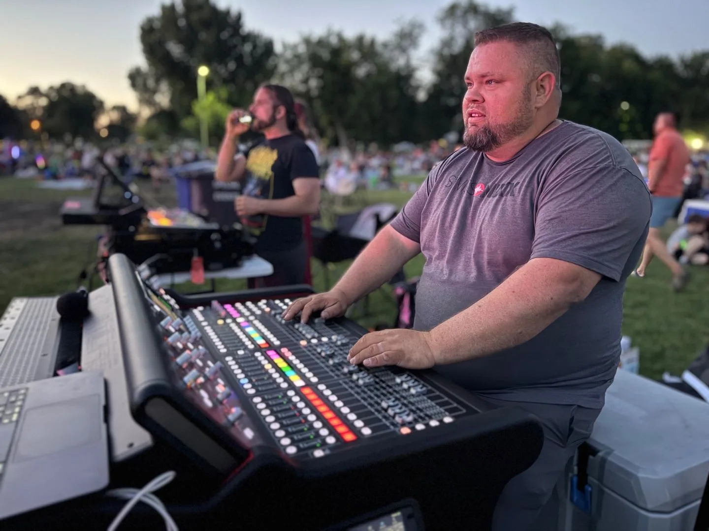 Mark Christiansen mixing live event sound at outdoor stage at night, RCF line array PA system, SwissMixx Audio Boise Idaho