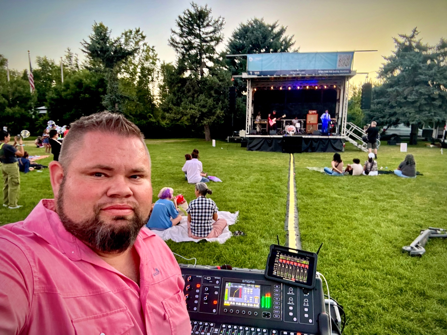 Mark Christiansen, SwissMixx Audio owner and audio engineer, at the Midas console running front-of-house sound at an outdoor live event in Idaho