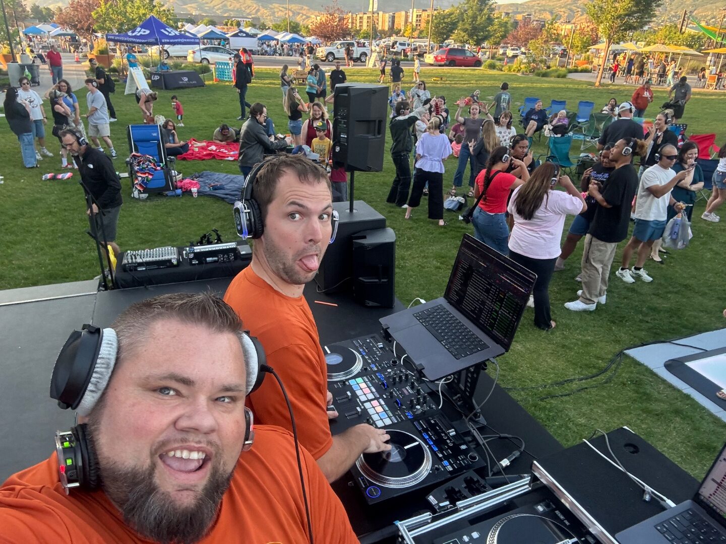 Mark Christiansen and team DJing an outdoor park silent disco with a huge crowd wearing LED wireless headsets dancing behind him, SwissMixx Audio Treasure Valley Idaho