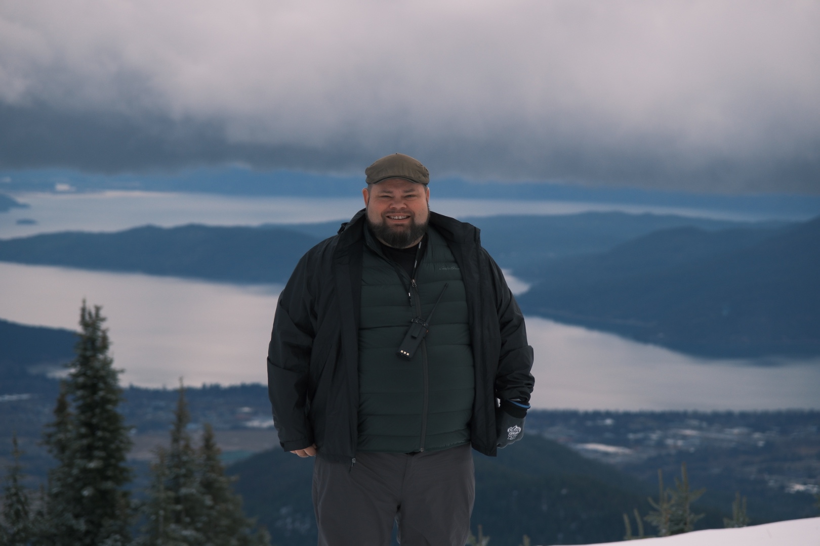 Mark at Schweitzer Mountain summit overlooking Lake Coeur d'Alene and snowy peaks, SwissMixx Audio destination wedding DJ Sandpoint Idaho