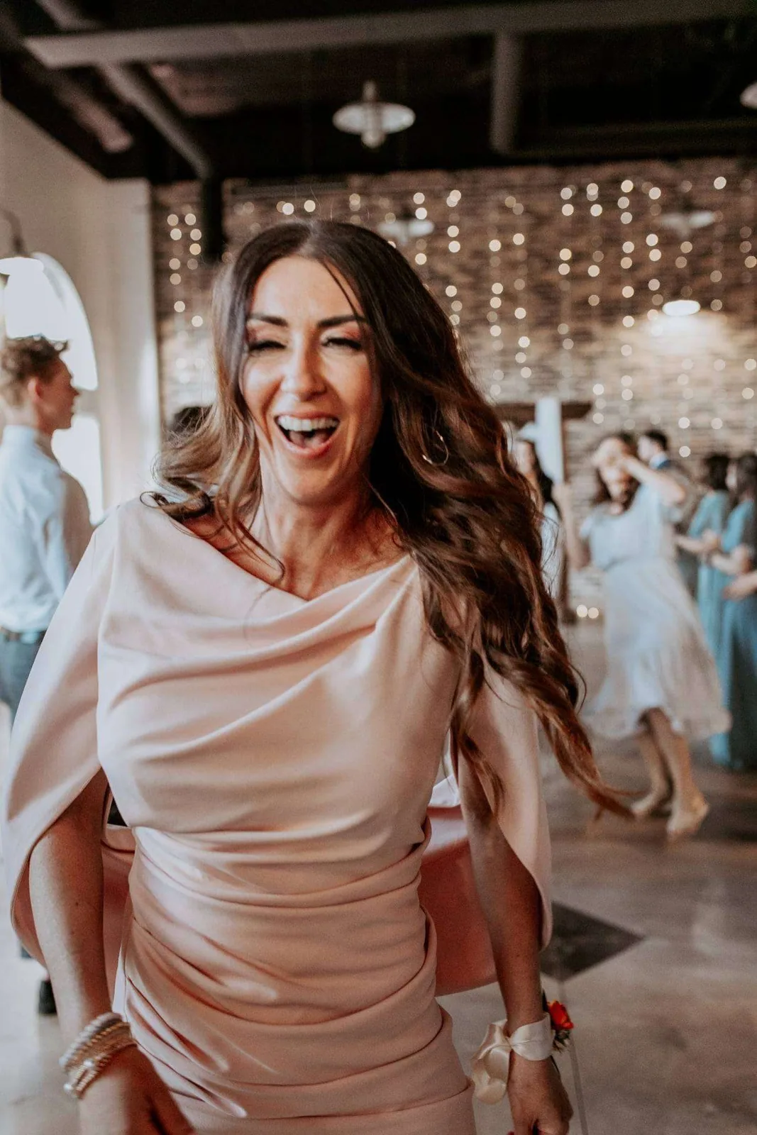 Bride laughing during wedding toasts at an Idaho reception with SwissMixx Audio