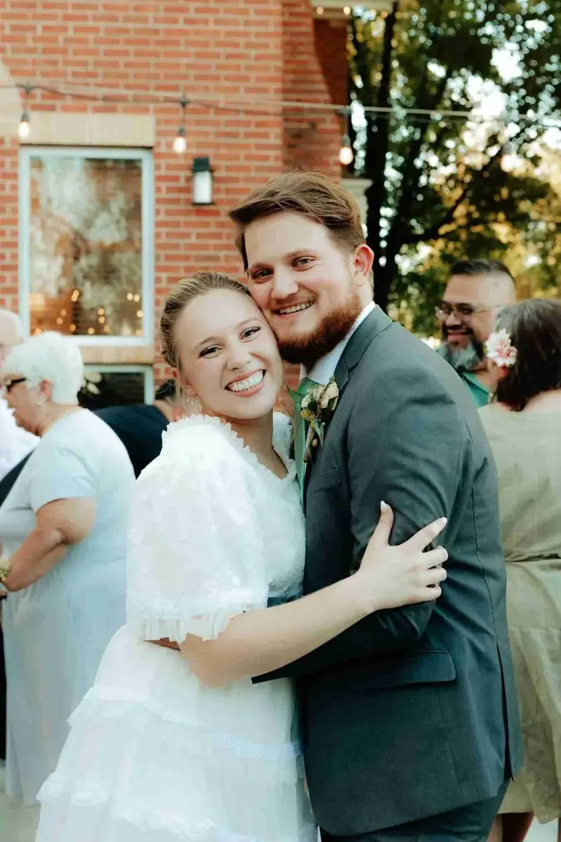 Bride and groom embracing guests during cocktail hour at a Treasure Valley wedding