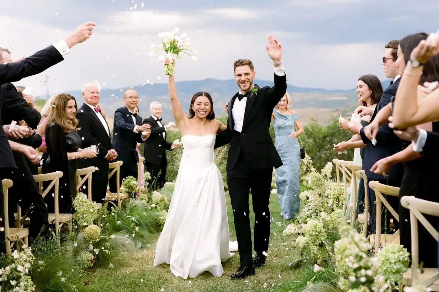 Bride and groom celebrating during their outdoor mountain wedding recessional in Idaho, guests cheering, sound by SwissMixx Audio